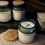 Candle jars with labels on a surface with books and papers