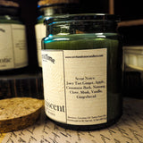 Candle jar with label on a surface with other candles in the background describing scent notes