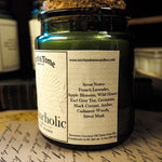 Candle jar with label on a surface with other candles in the background