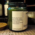 Candle jar with a label on a surface with other similar jars in the background