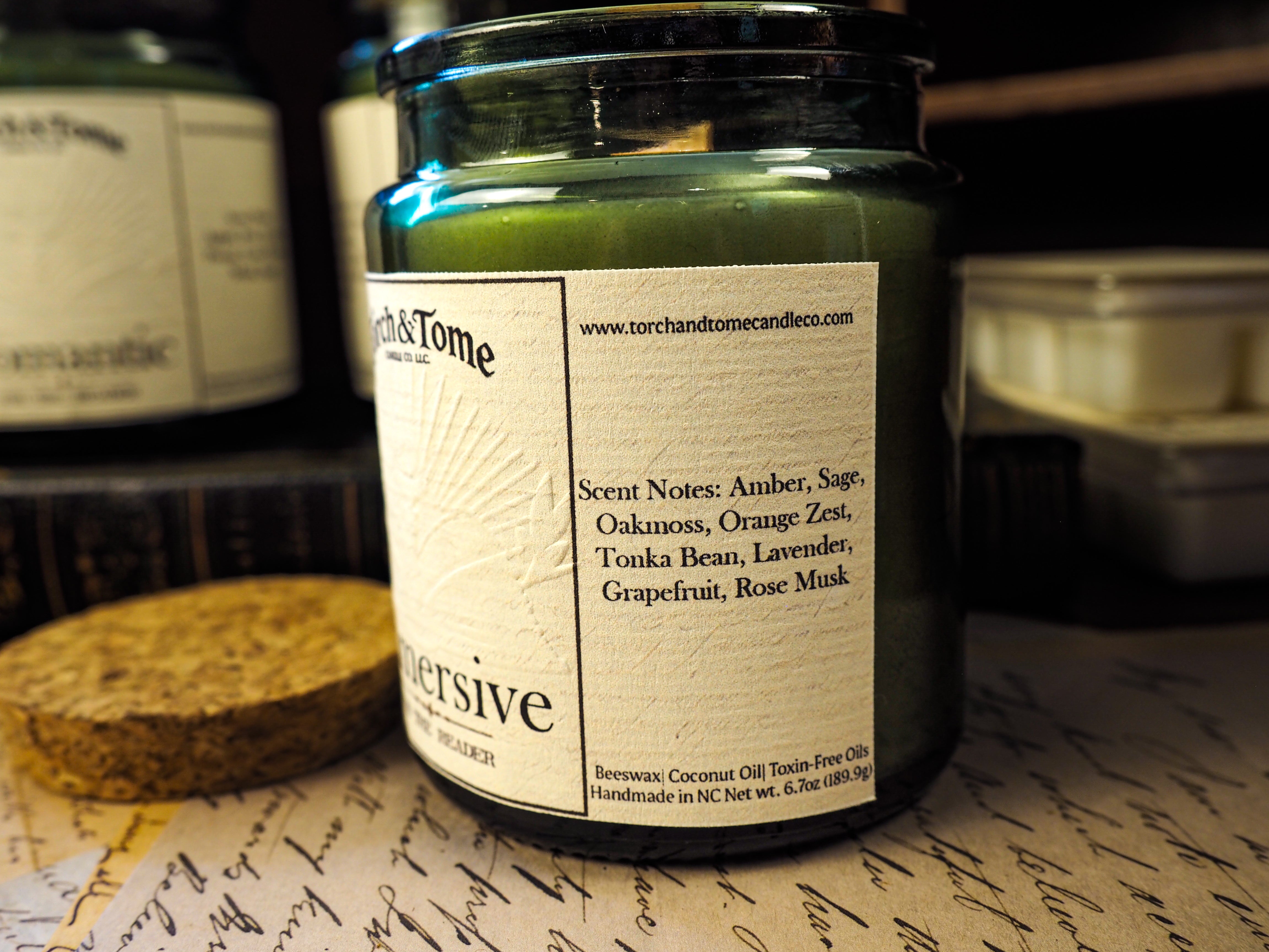 Candle jar with a label on a textured surface