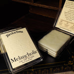 Torch & Tome Melancholic wax melts packaging on a dark background