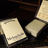 Torch & Tome Melancholic wax melts packaging on a dark background