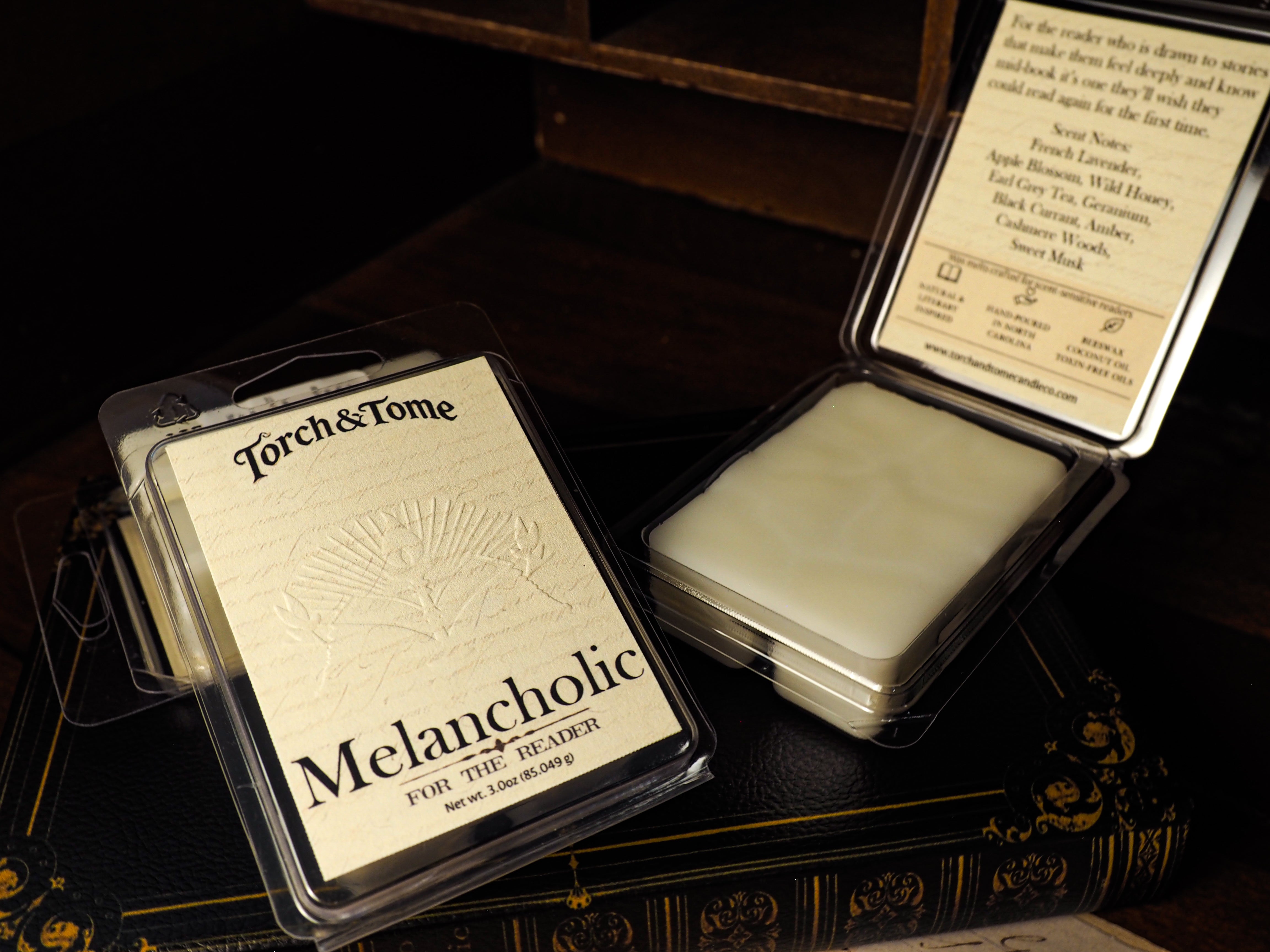 Torch & Tome Melancholic wax melts packaging on a dark background