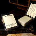 Torch & Tome Melancholic wax melts packaging on a dark surface with an open container.