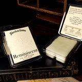 Two wax melt clamshell containters with 'Torch & Tome' branding on top of a book writing desk.