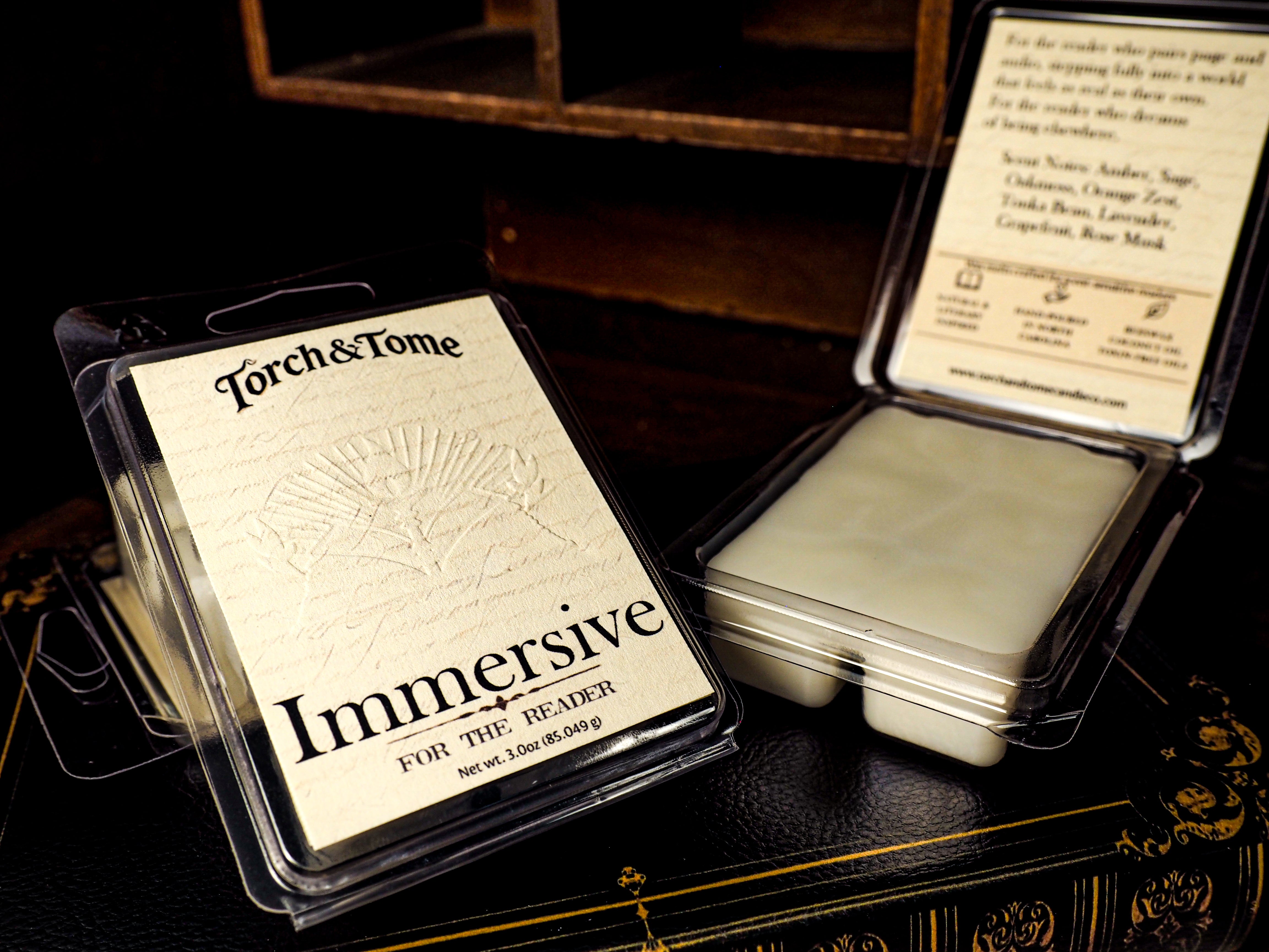 Torch & Tome Immersive waxmelts in packaging on a dark surface