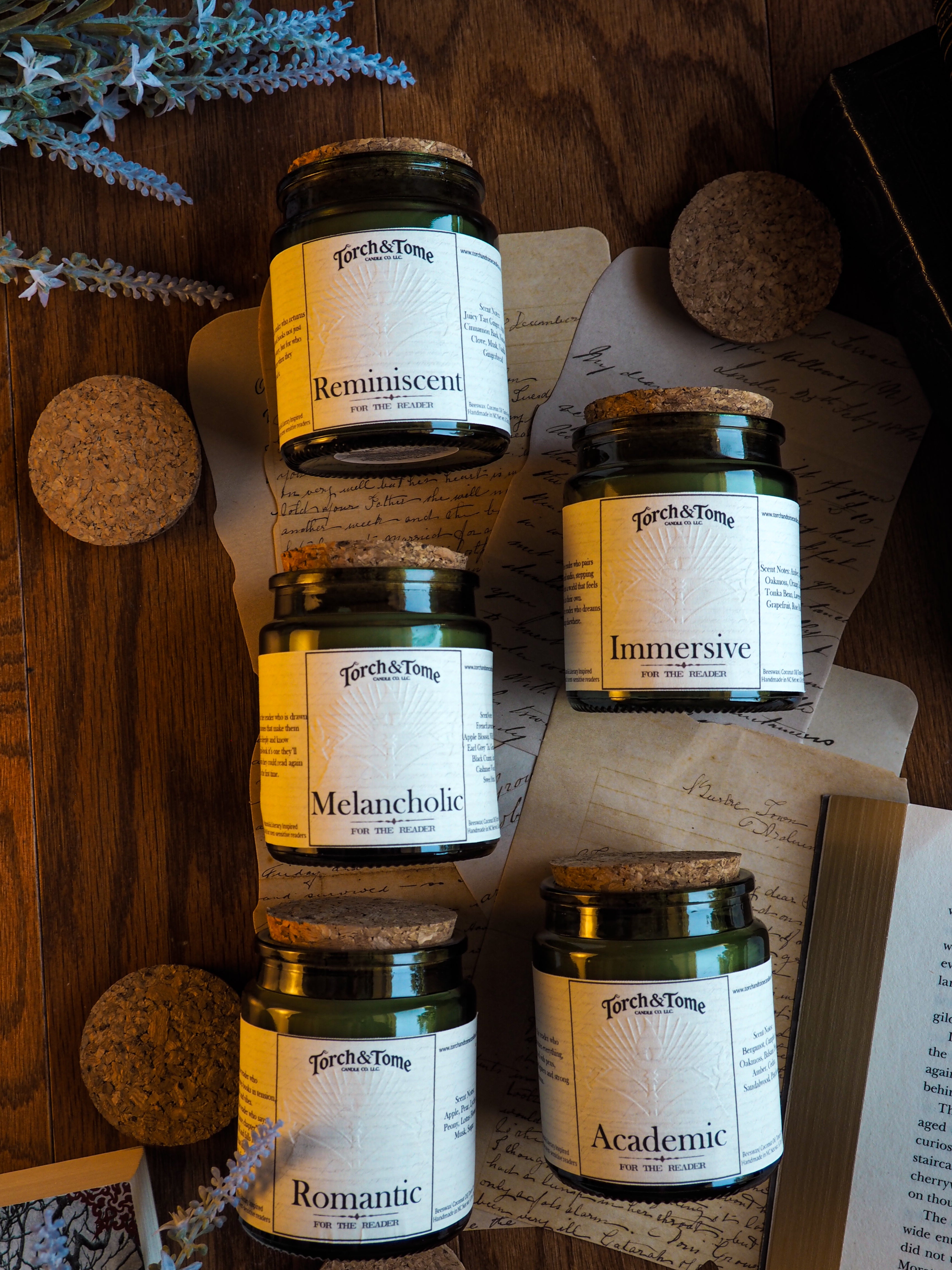 Five jars labeled 'Reminiscent', 'Immersive', 'Melancholic', 'Romantic', and 'Academic' on a wooden surface with decorative elements.