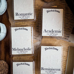 Collection of Torch & Tome waxmelts on a textured surface with visible branding.