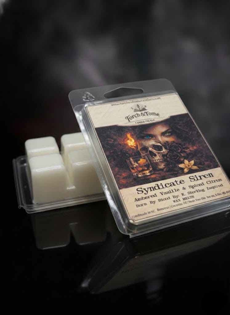 Syndicate Siren wax melt package with label depicting a female, black roses, vanilla flower, whiskey glass, and a skull on a dark smoky background. A second wax melt clamshell is propped upside down showing the ivory beeswax