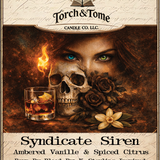 Closeup of the Syndicate Siren label. Featuring a woman with one blue eye and one green eye, a skull and black roses, with text about the candle's scent and ingredients. Ambered Vanille & Spiced Citrus scent notes.