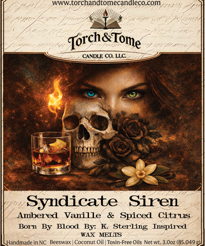 Closeup of the Syndicate Siren label. Featuring a woman with one blue eye and one green eye, a skull and black roses, with text about the candle's scent and ingredients. Ambered Vanille & Spiced Citrus scent notes.