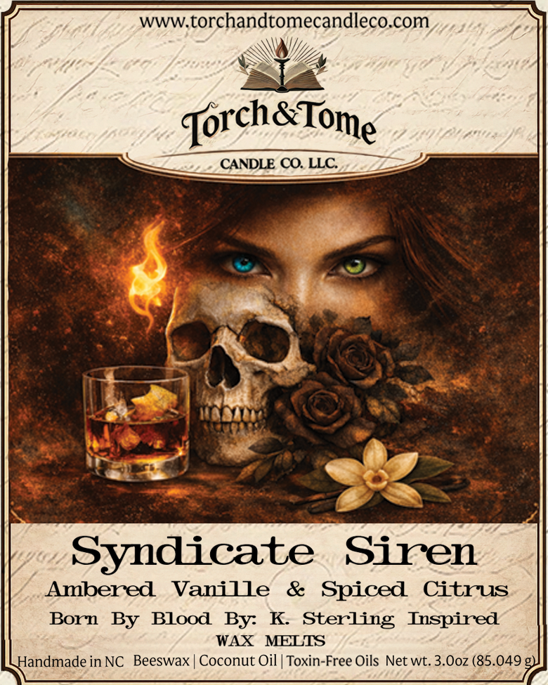 Closeup of the Syndicate Siren label. Featuring a woman with one blue eye and one green eye, a skull and black roses, with text about the candle's scent and ingredients. Ambered Vanille & Spiced Citrus scent notes.